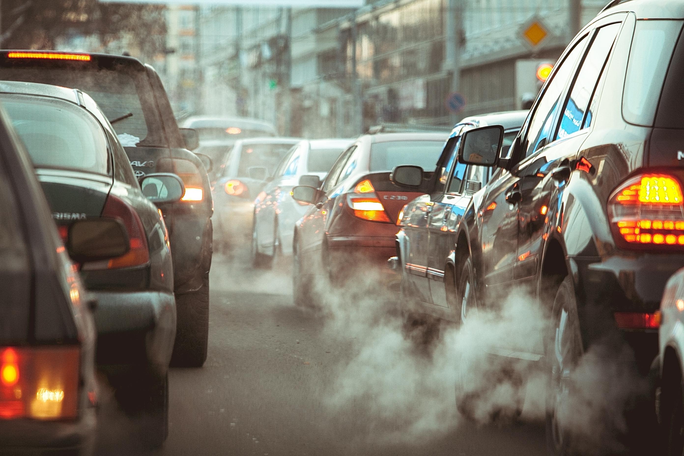 cars with exhaust smoke in a main lane