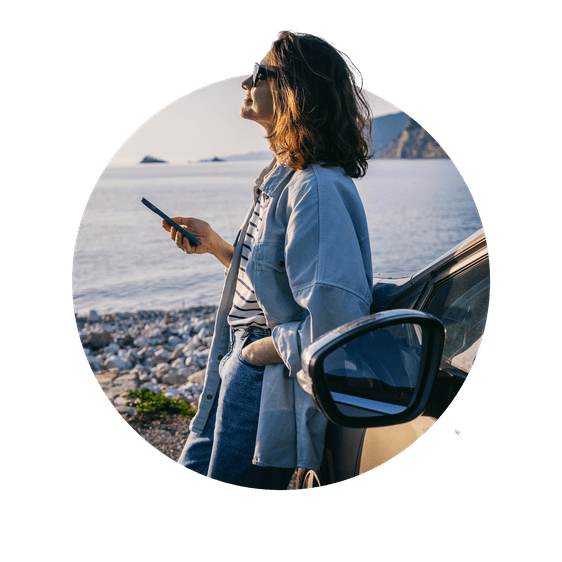 Woman on beach with car