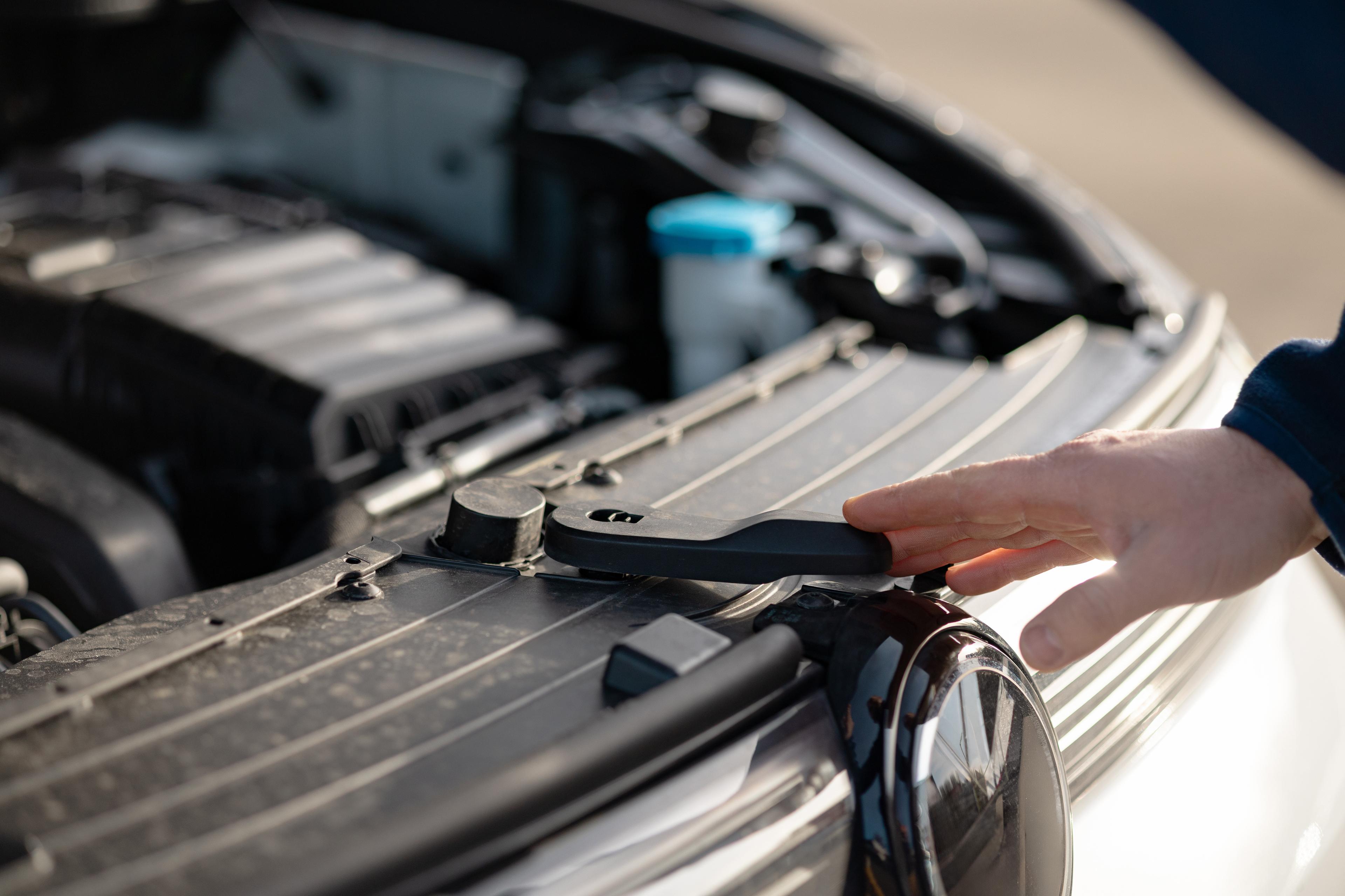 Mechanic opens car bonnet