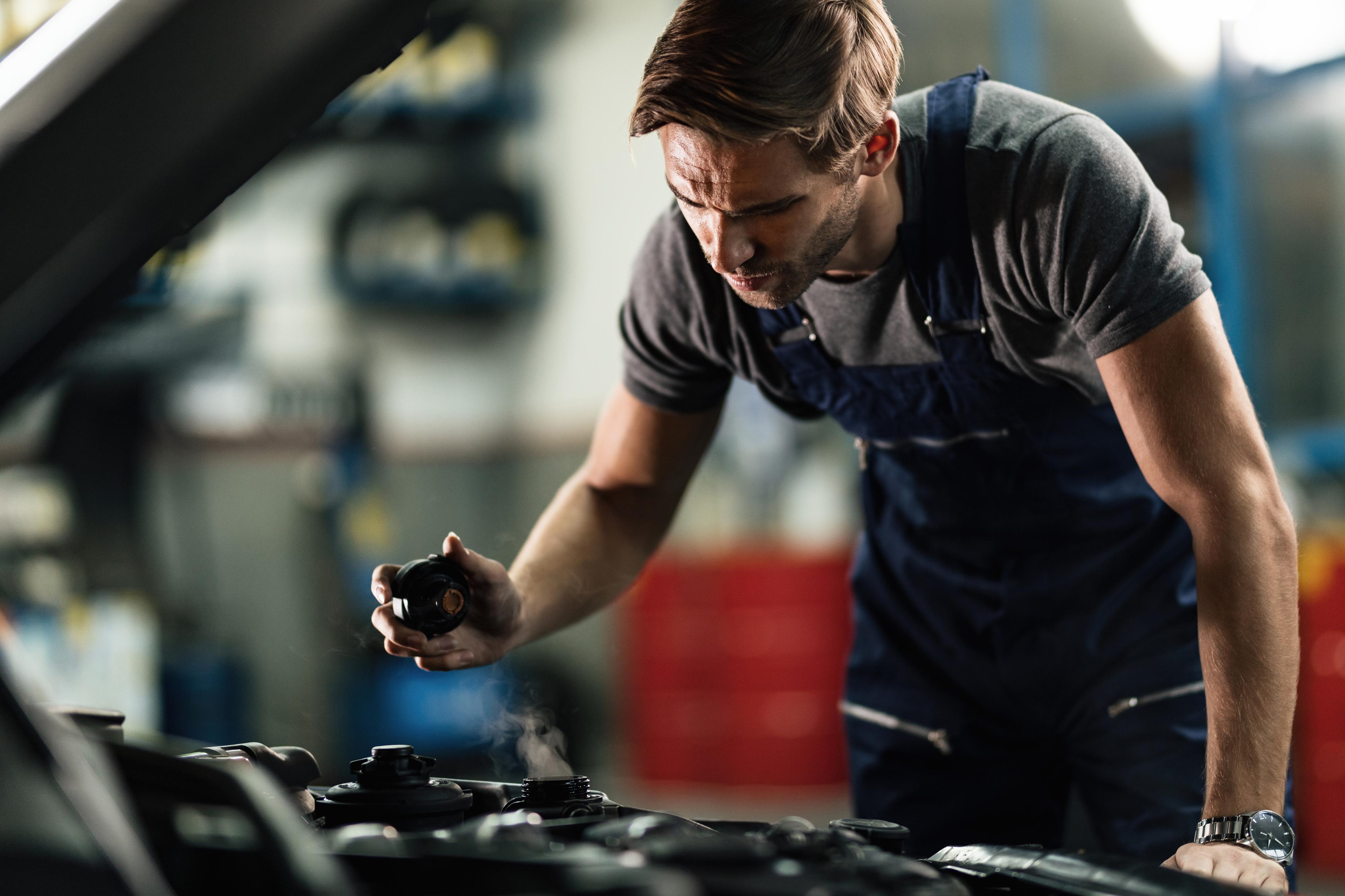 Mechanic fixing a coolant system