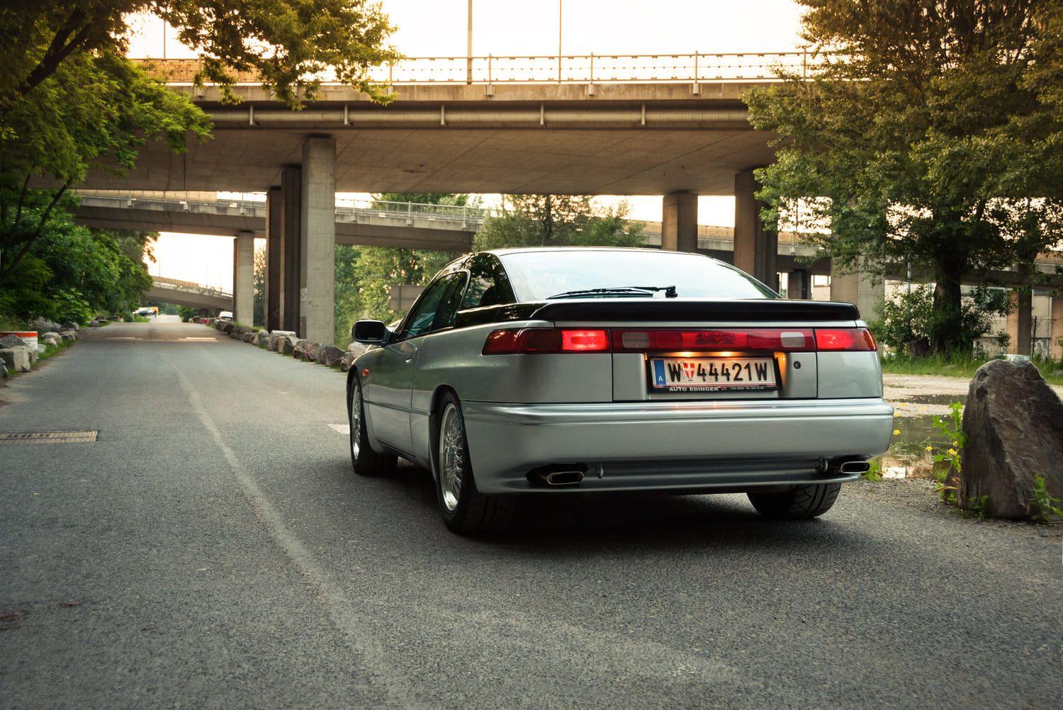 90s car next to a bridge
