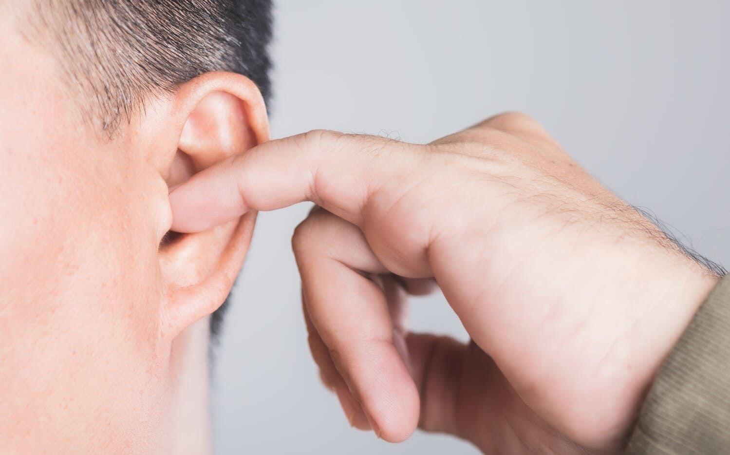 Person picking their ear