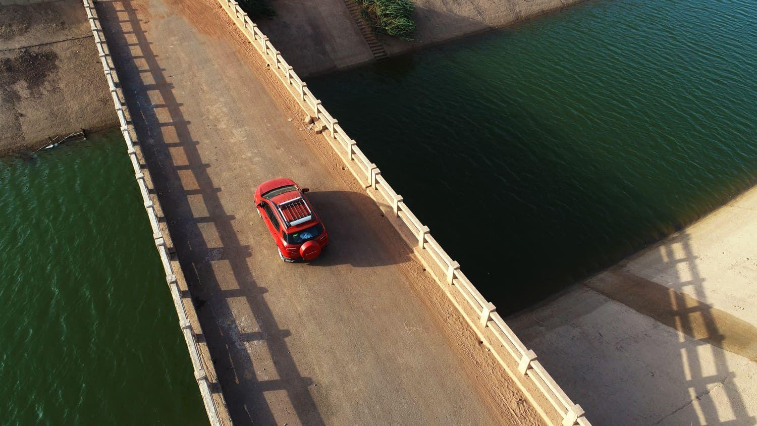 SUV driving along a bridge