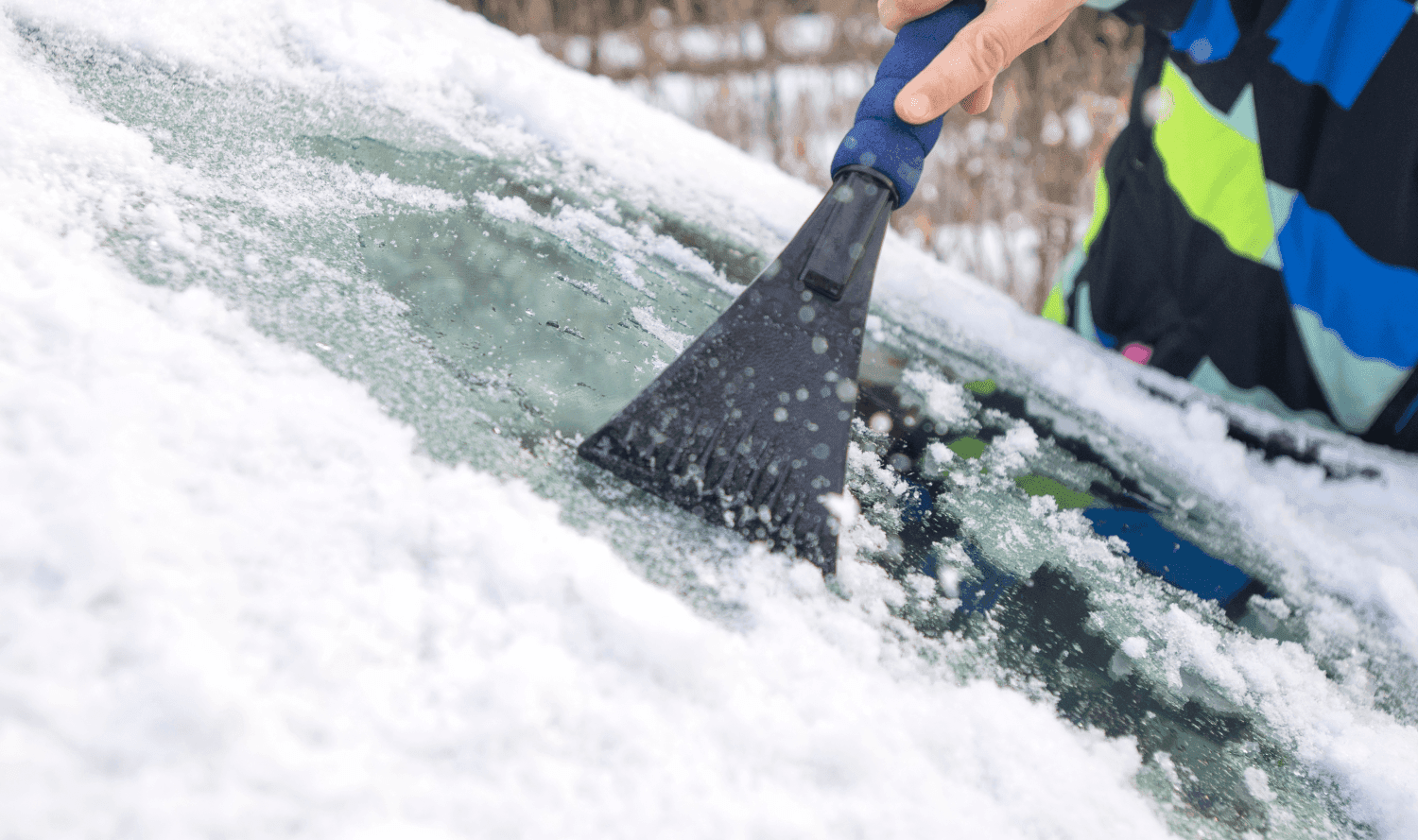 Driver scraping windscreen