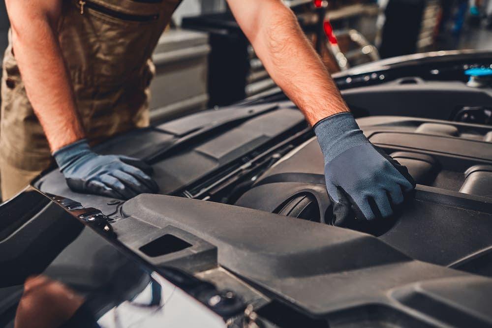 Man looking at a car undertray