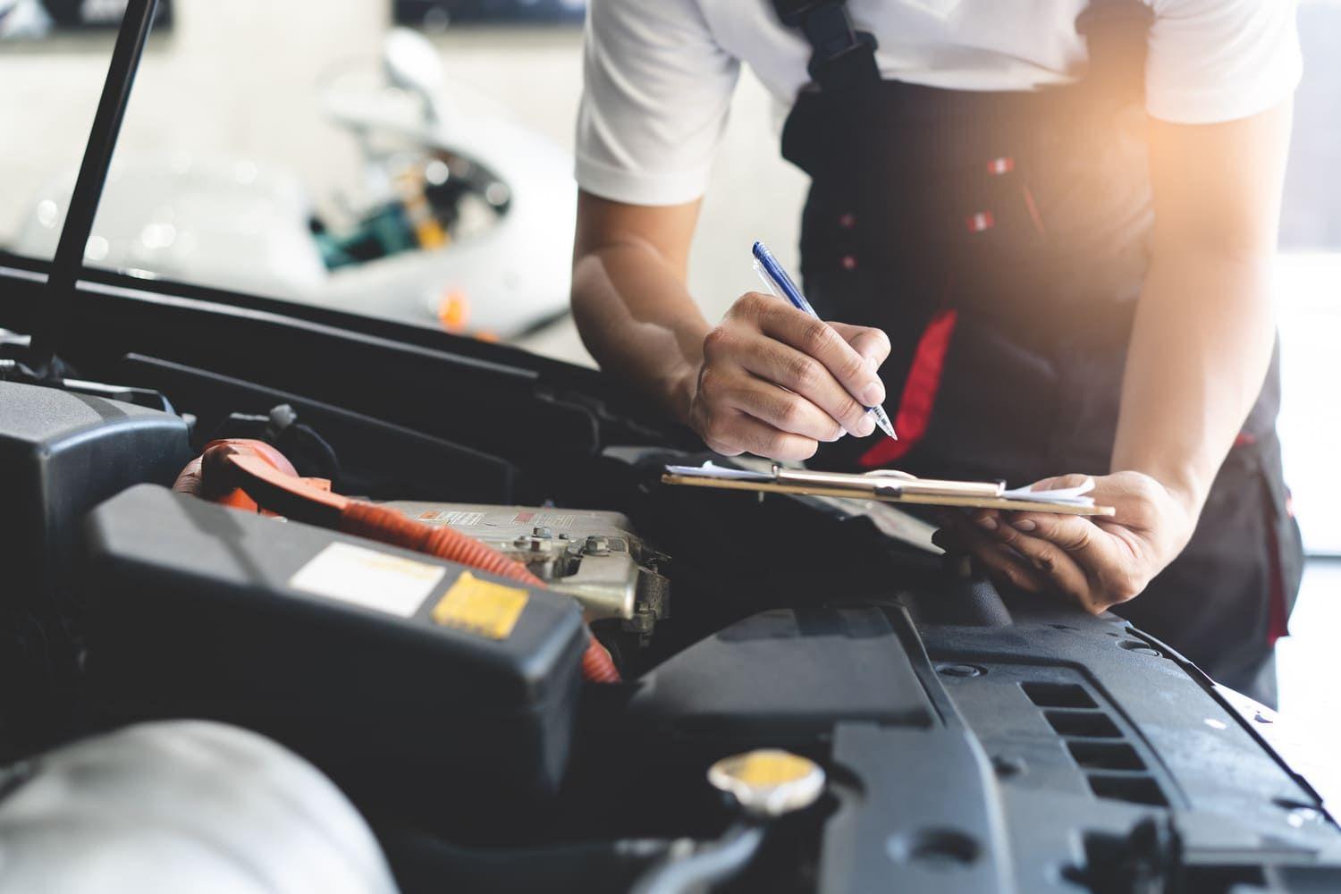 Mechanic carries out an MOT check