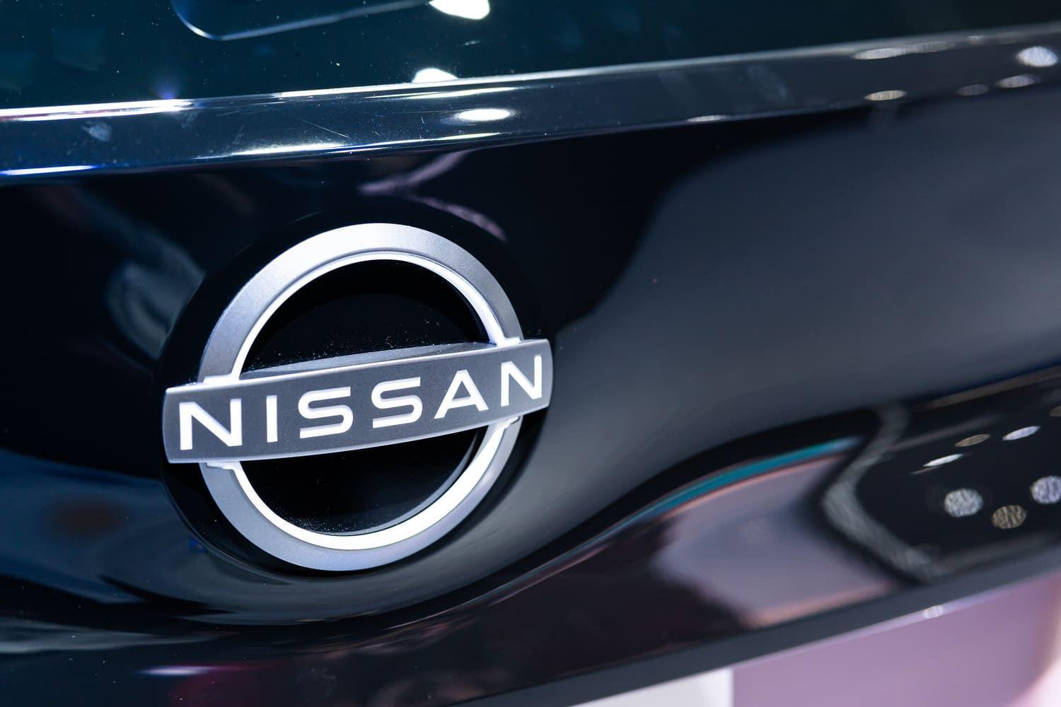 Nissan badge on a black shiny car