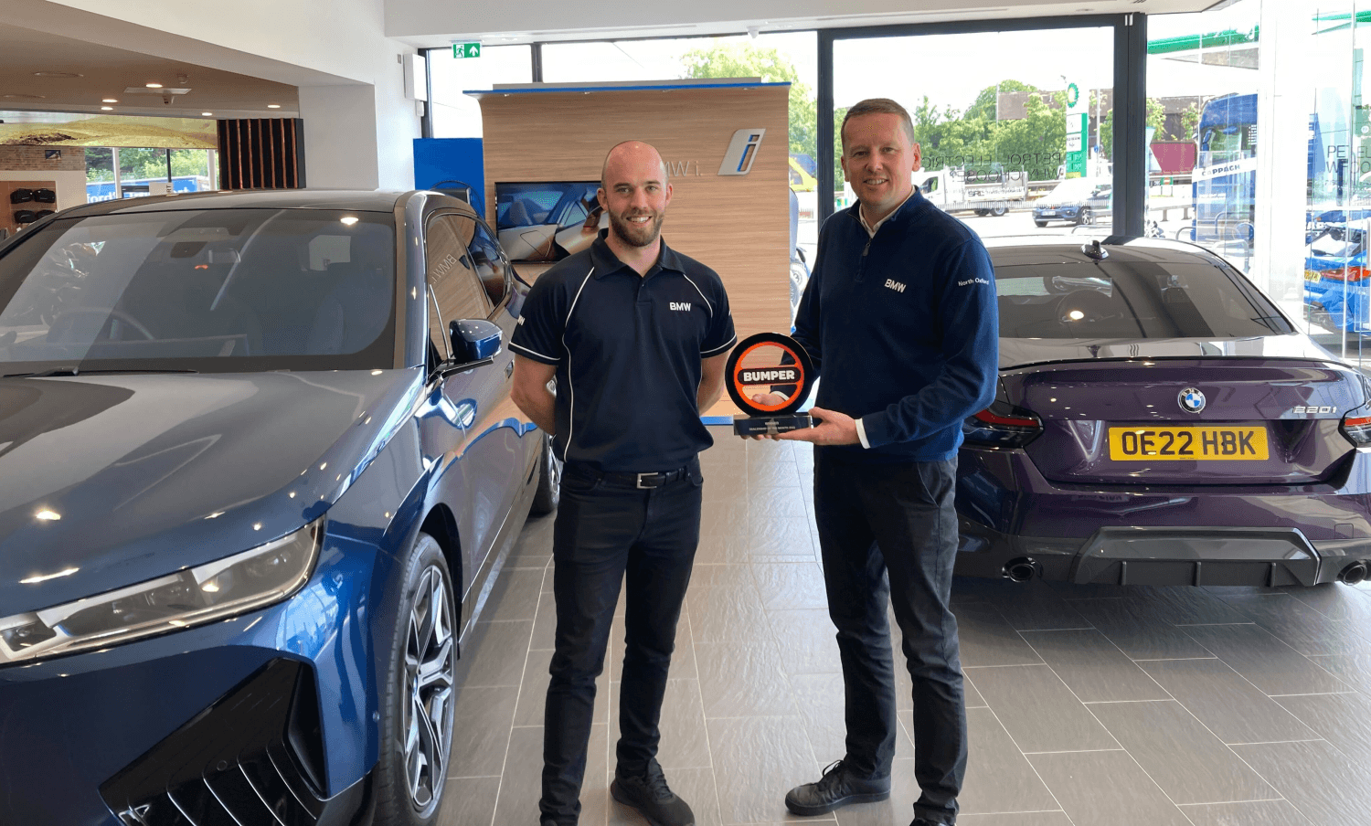 The winning dealerships stands with the award