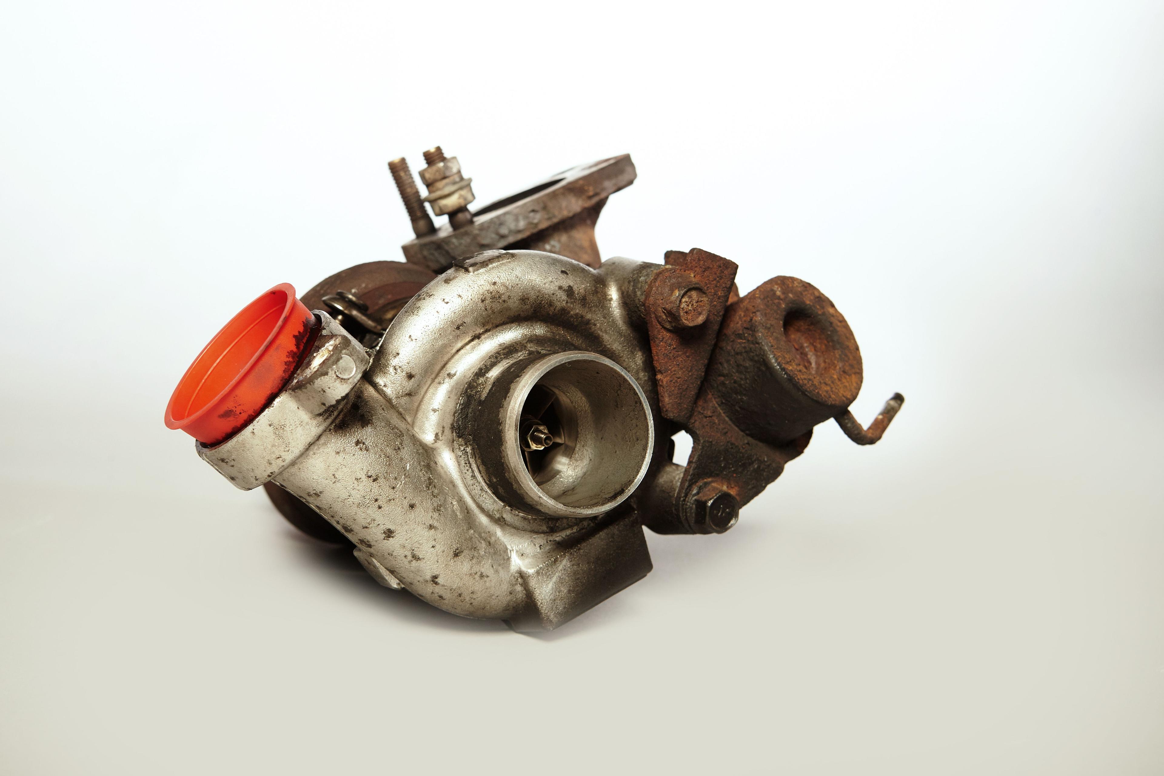 A rusty and carbonized turbo charger